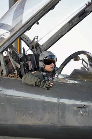Grayson seated in a military aircraft cockpit